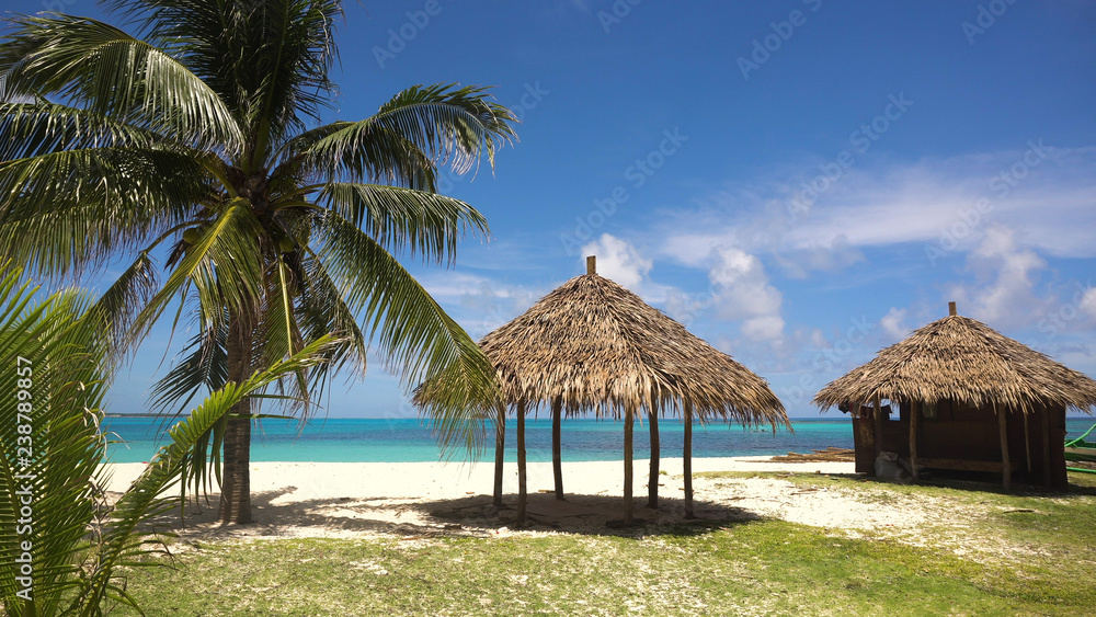 Beach with white sand with beach house on a tropical island Daco. Beautiful sky, sea, resort. Seascape: Ocean and beautiful beach paradise. Philippines. Travel concept.