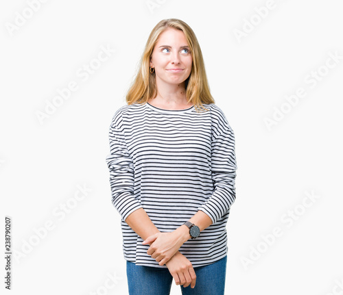 Beautiful young woman wearing stripes sweater over isolated background smiling looking side and staring away thinking.