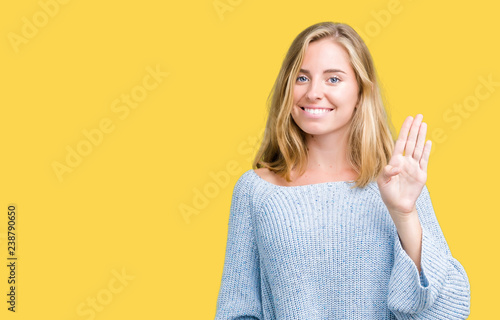 Wallpaper Mural Beautiful young woman wearing blue sweater over isolated background Waiving saying hello happy and smiling, friendly welcome gesture Torontodigital.ca