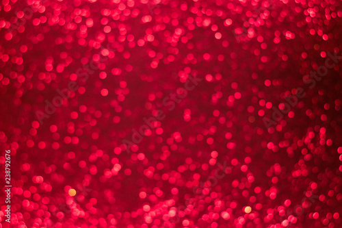 Holiday shiny red bokeh background, glitter, sparkles, defocused glow