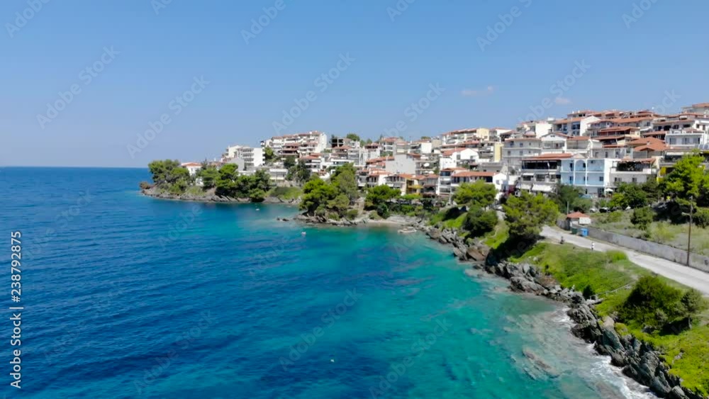Drone aerial view over blue sea water on coast of Neos Marmaras town on the Sithonia , Chalkidiki , Greece Drone aerial view over blue sea water on coast of Neos Marmaras town on the Sithonia , Chalkidiki , Greece