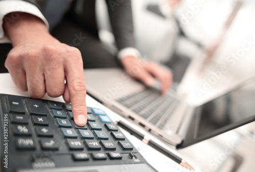 close up.businessman using a calculator for calculating financial profit.