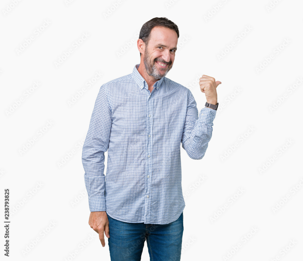 Handsome middle age elegant senior man over isolated background smiling with happy face looking and pointing to the side with thumb up. Handsome middle age elegant senior man over isolated background smiling with happy face looking and pointing to the side with thumb up.