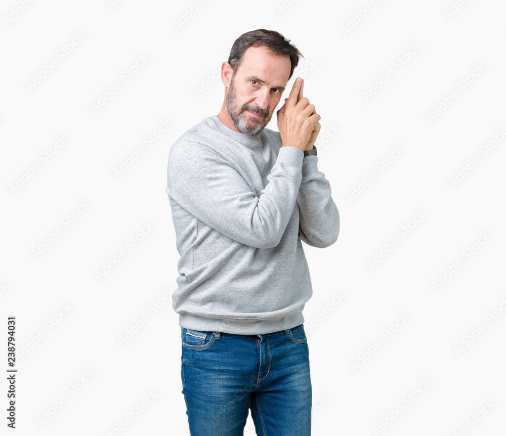 Handsome middle age senior man wearing a sweatshirt over isolated background Holding symbolic gun with hand gesture, playing killing shooting weapons, angry face Handsome middle age senior man wearing a sweatshirt over isolated background Holding symbolic gun with hand gesture, playing killing shooting weapons, angry face
