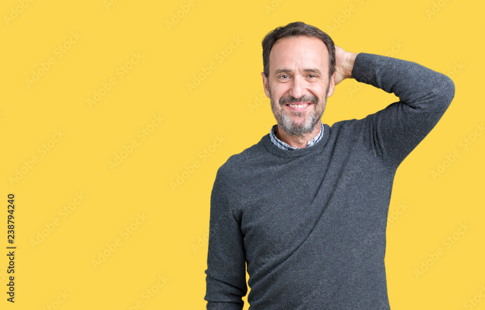 Handsome middle age senior man wearing a sweater over isolated background Smiling confident touching hair with hand up gesture, posing attractive