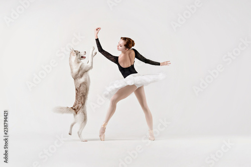 Young ballerina in black with a dog.