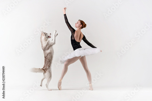 Young ballerina in black with a dog.
