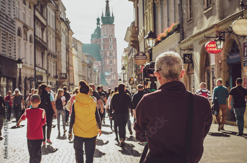 Fototapeta Naklejka Na Ścianę i Meble -  13.07.2018 Krakow, Poland: tourist travel photographer taking photo of the street with dslr camera, photography point of view