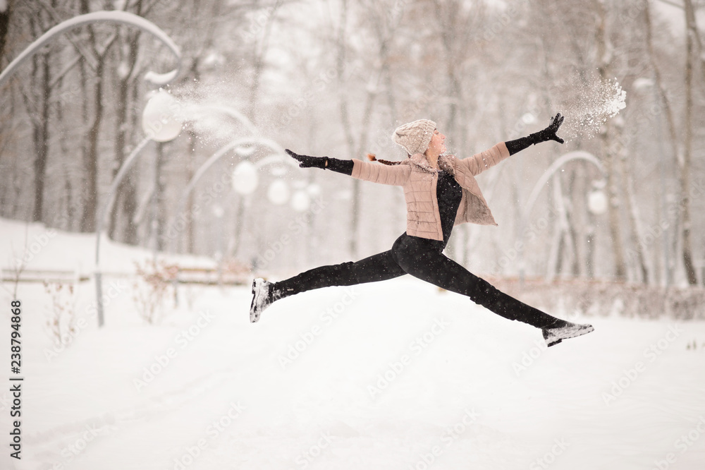 Girl gymnast, performs various gymnastic and fitness exercises. A healthy lifestyle. Winter
