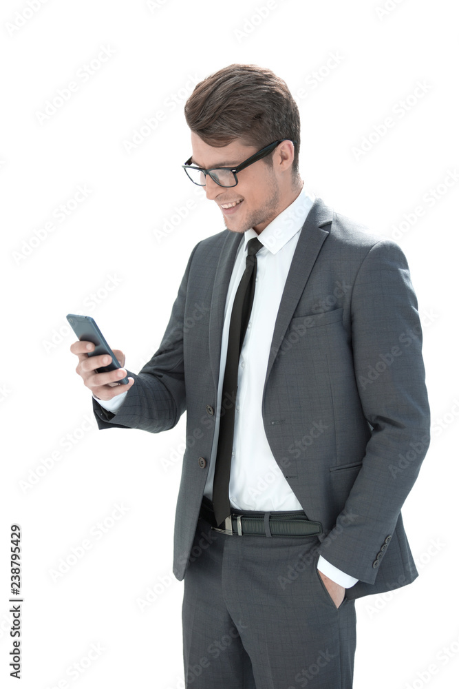 smiling businessman looking at the screen of his smartphone smiling businessman looking at the screen of his smartphone
