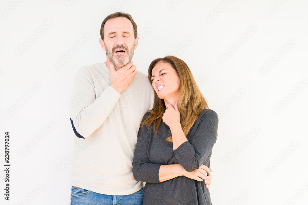 Beautiful middle age couple in love over isolated background Touching painful neck, sore throat for flu, clod and infection Beautiful middle age couple in love over isolated background Touching painful neck, sore throat for flu, clod and infection