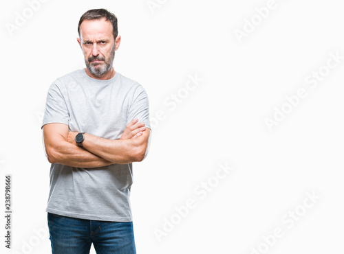 Middle age senior hoary man over isolated background skeptic and nervous, disapproving expression on face with crossed arms. Negative person.