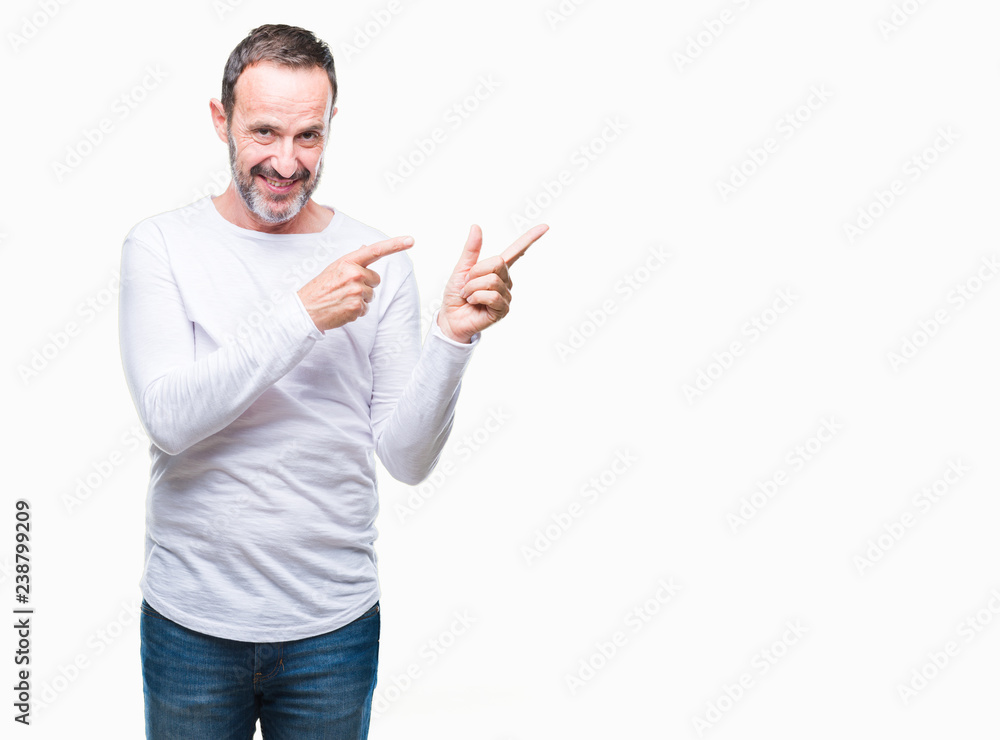 Middle age hoary senior man wearing white t-shirt over isolated background smiling and looking at the camera pointing with two hands and fingers to the side. Middle age hoary senior man wearing white t-shirt over isolated background smiling and looking at the camera pointing with two hands and fingers to the side.