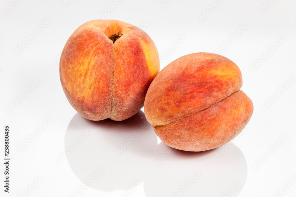 Peach isolated on white reflective background Peach isolated on white reflective background