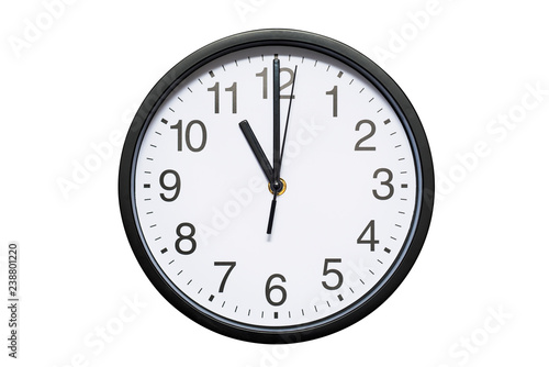 Wall clock shows time 11 o'clock on white isolated background. Round wall clock - front view. Eleven o'clock