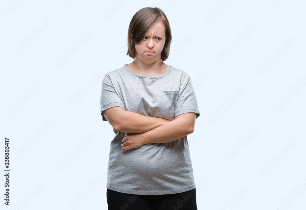 Young adult woman with down syndrome over isolated background skeptic and nervous, disapproving expression on face with crossed arms. Negative person. Young adult woman with down syndrome over isolated background skeptic and nervous, disapproving expression on face with crossed arms. Negative person.