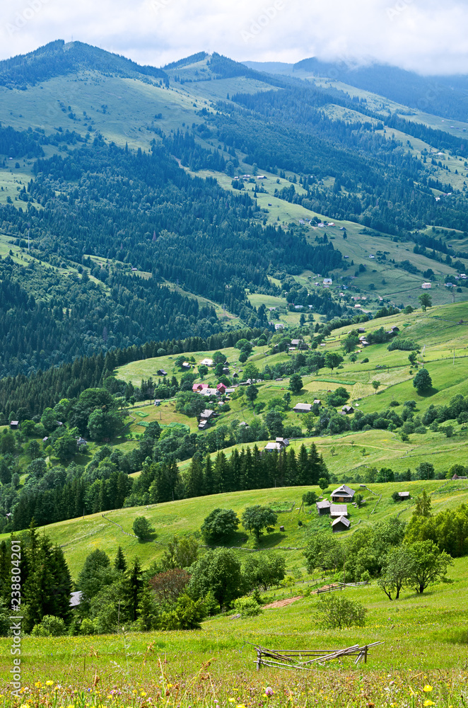 aerial view on mountain slopes with houses. Carpathians Ukraine