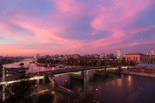 Evening  twilight and night view  red sunset over Moskva river and red skies  Novospassky Monastery  New monastery of the Saviour  the New Saviour  and Novospasskiy Bridge in Moscow  Russia.