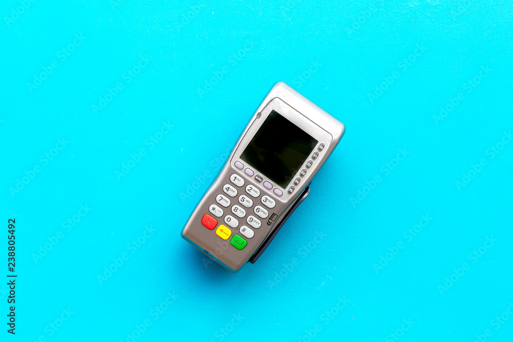 Payment terminal, compact POS terminal on blue background top view space for text Payment terminal, compact POS terminal on blue background top view space for text