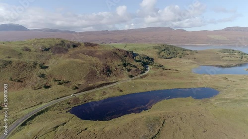 Aerial view oversmall lock near Loch Hope, Scotland. A white camper van can be seen on the road below. photo