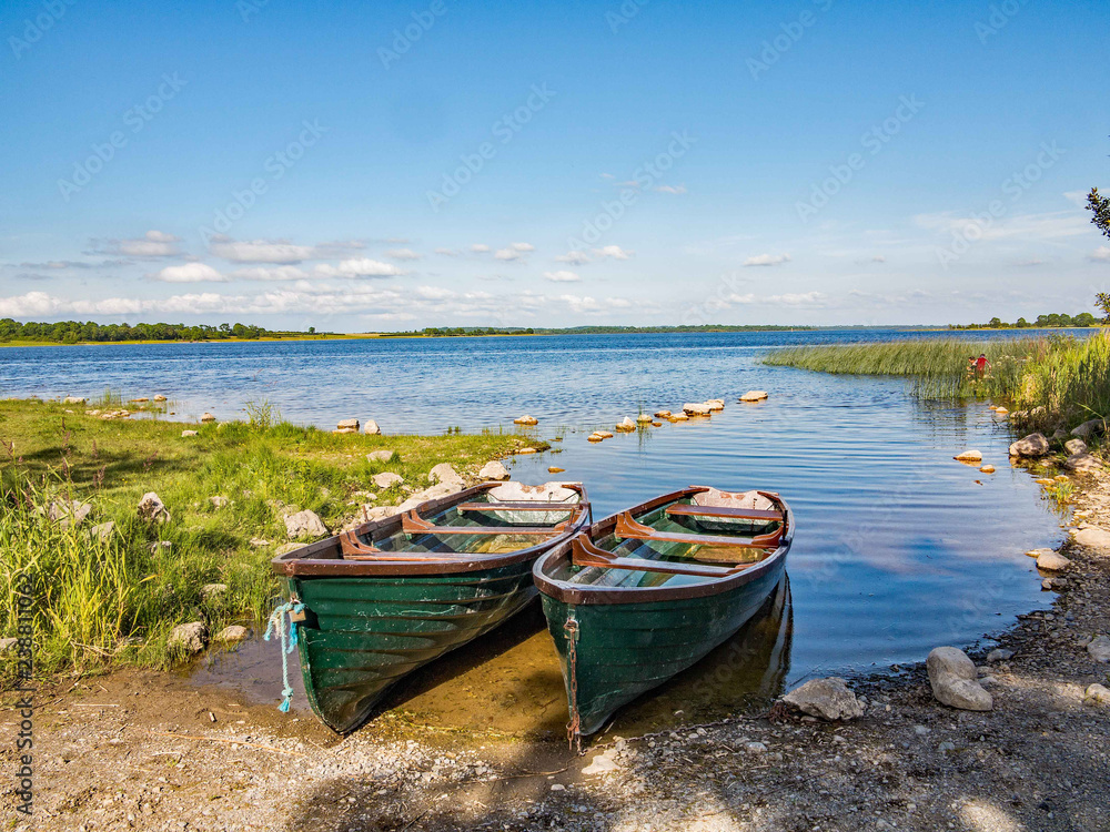 Wooden boats moored up on the edge of the lake