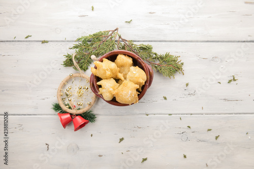 Tipical christmasapulian food called pettole on light wooden background with copy space photo