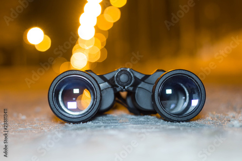 Binoculars closeup in the winter season. Evening time of day