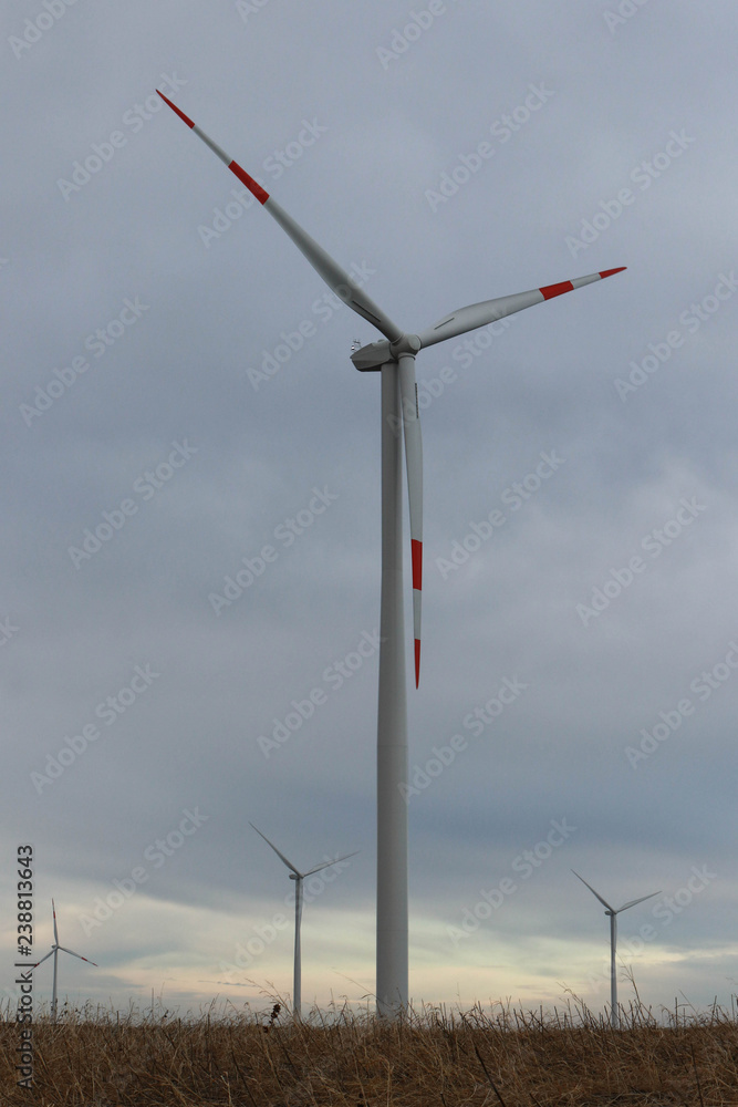 Wind farm installed in the field, cloudy day Wind farm installed in the field, cloudy day