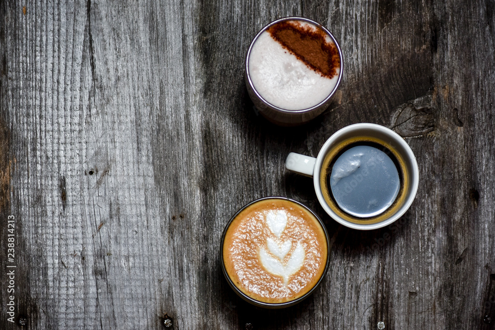 Collage of cups with tasty coffee on wood rustic background Collage of cups with tasty coffee on wood rustic background
