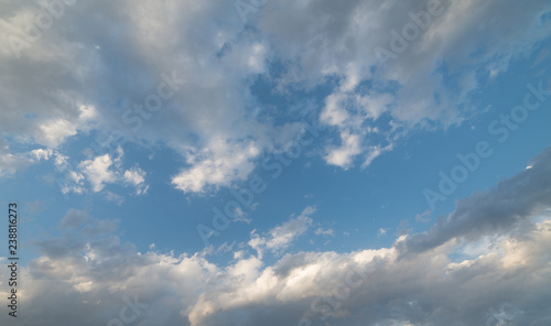 Clear bright blue sky with sunny clouds - perfect for background. Blue, white pastel heaven in soft focus. Simple shot of peaceful and beautiful nature. Opened, minimalist view out of windows. - Image © Ivan