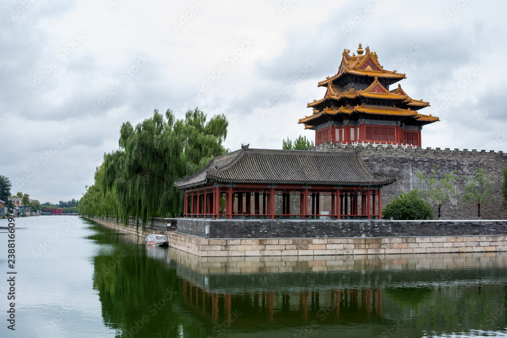Corner tower and pavilion of The Forbidden City (north east corner) showing reflections in the surrounding tongzi river, Beijing, China.