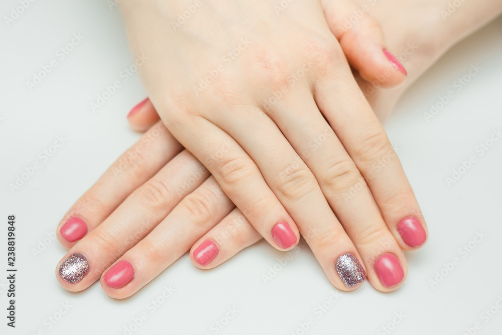 Hands with long artificial manicured nails colored with red nail polish Hands with long artificial manicured nails colored with red nail polish