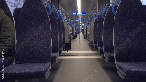 Passenger preparing to disembark moving train. photo