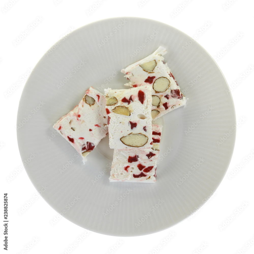 French soft nougat with strawberry flawour and almonds isolated on white background. Greek manolato. French soft nougat with strawberry flawour and almonds isolated on white background. Greek manolato.