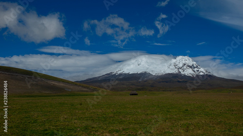 Panoramic view of Antisana volcano in a day with cloudy blue sky. Antisana is a stratovolcano of the northern of Ecuadorian Andes