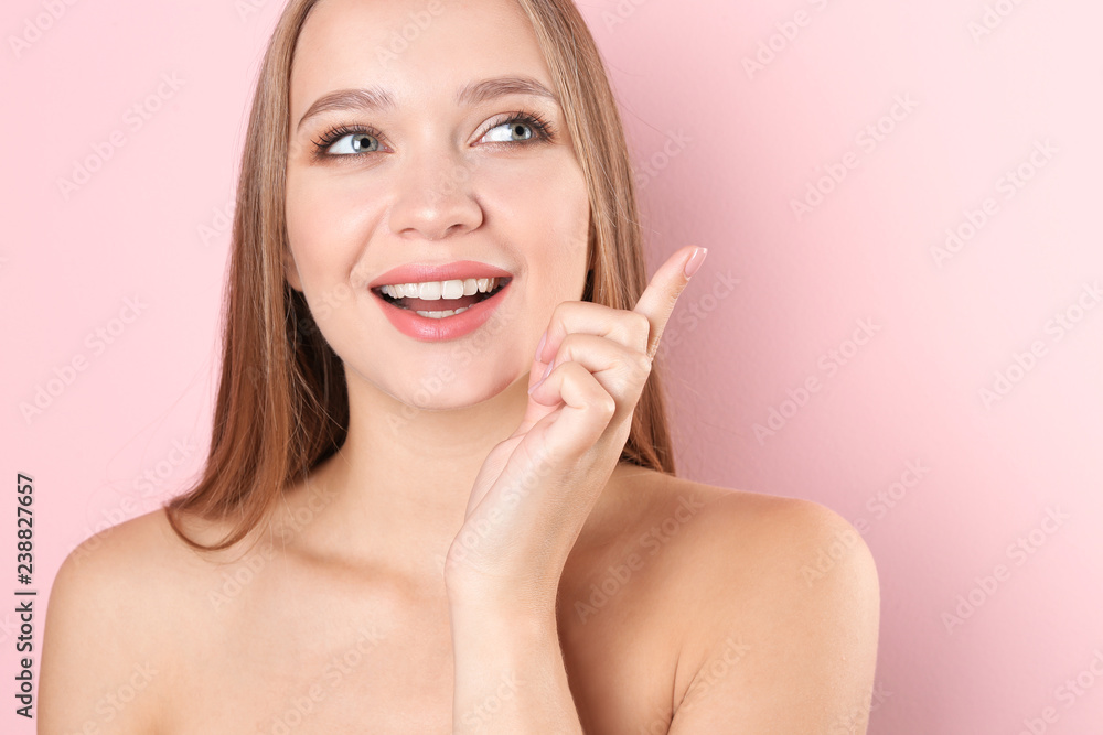 Portrait of beautiful young woman with natural makeup on color background