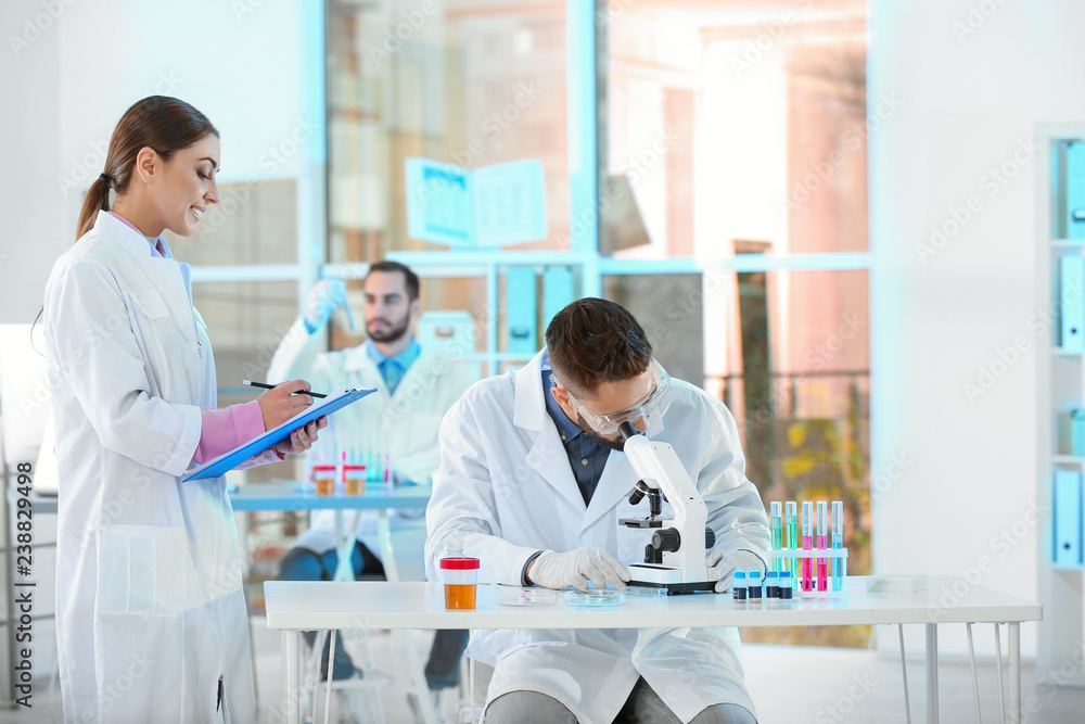 Young scientists working in laboratory. Chemical analysis Young scientists working in laboratory. Chemical analysis