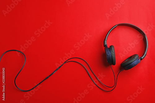 Stylish headphones on color background, top view. Space for text