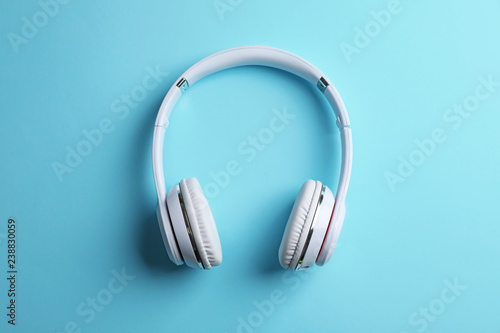 Wireless headphones on color background, top view