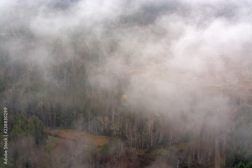 Aerial photo over foggy but green Swedish landscape