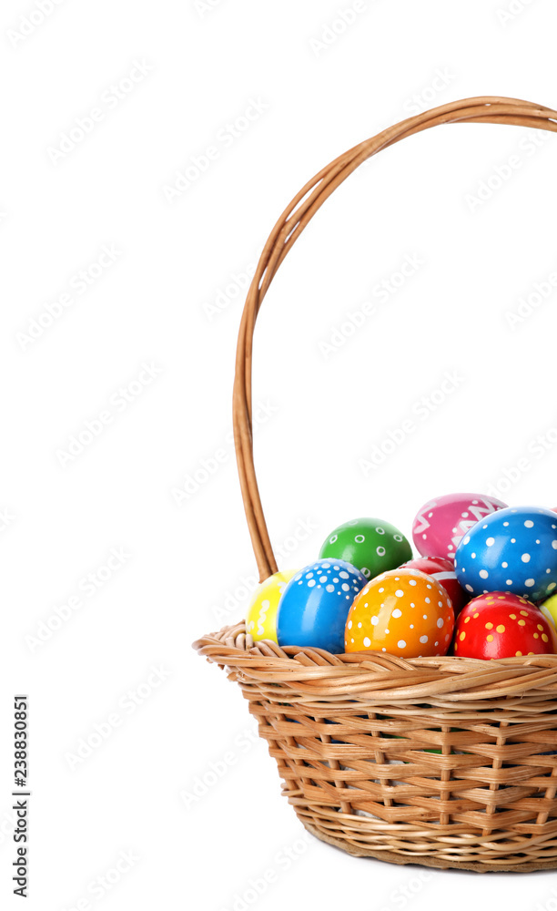 Decorated Easter eggs in wicker basket on white background Decorated Easter eggs in wicker basket on white background
