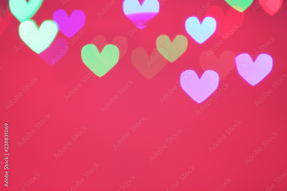 Blurred view of beautiful heart shaped lights on color background. Space for text