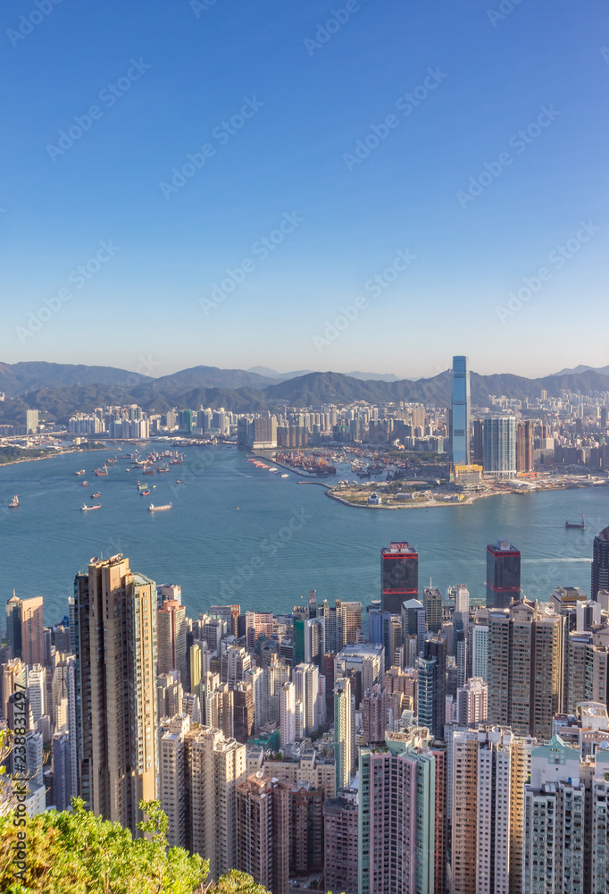 Hong Kong, China, skyline during sunrise as seen from Victoria Peak. Sky is  clear, no haze, boats can be seen on the water.