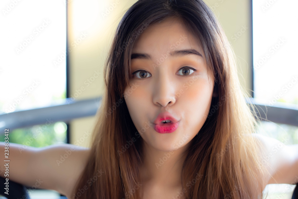 Portrait cheerful woman. Attractive beautiful women act like a kissing  someone or making funny face when