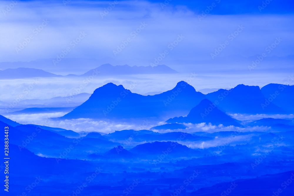 Landscape mountain with fog mist blue sky and rising sun in the morning