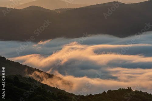 Fototapeta Naklejka Na Ścianę i Meble -  Whispy Clouds Cling to the Blue Ridge Mountains