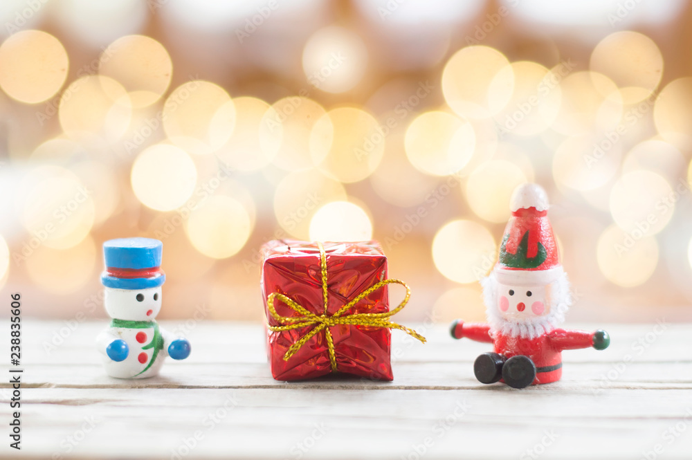 Santa Claus, Snowman doll and red gift box with shiny light for Christmas decoration background