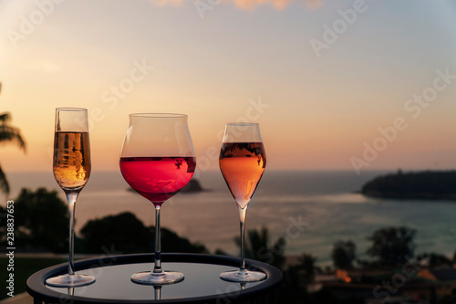 Different kind of cocktail glass, a glass of champagne, red wine and rose wine with sunset background, festive celebration. Christmas festive celebration. End of the year, Welcome start New Year 2019 
