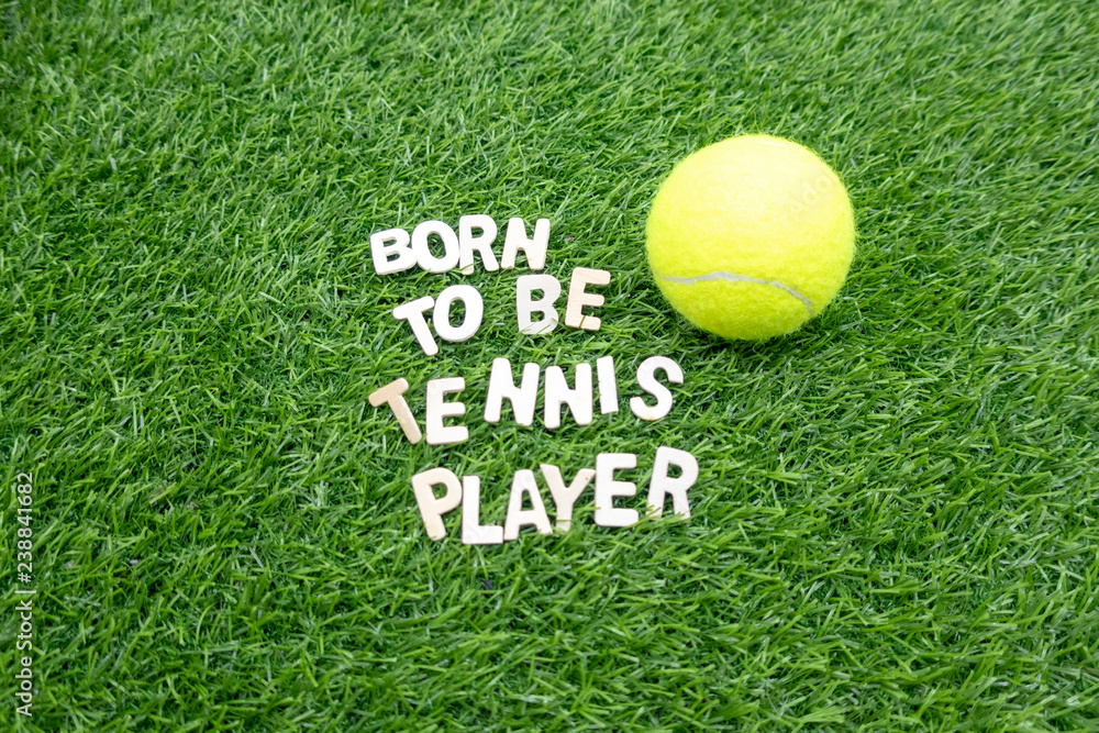 Tennis born to be tennis player with tennis ball on green grass