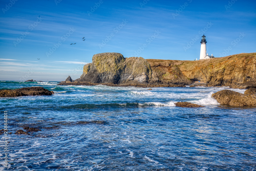 Yaquina Head Lighthouse, Newport, Oregon. The Lighthouse, at 93 feet (28 m) tall, is the tallest lighthouse in Oregon. Copy space frame left for text or graphics.